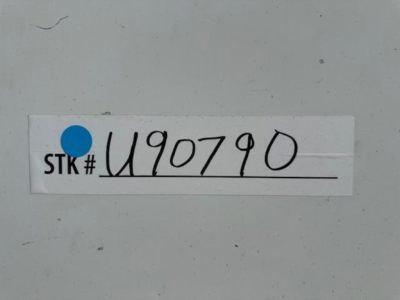 STK# U90790 handwritten on a label affixed to a gray surface.