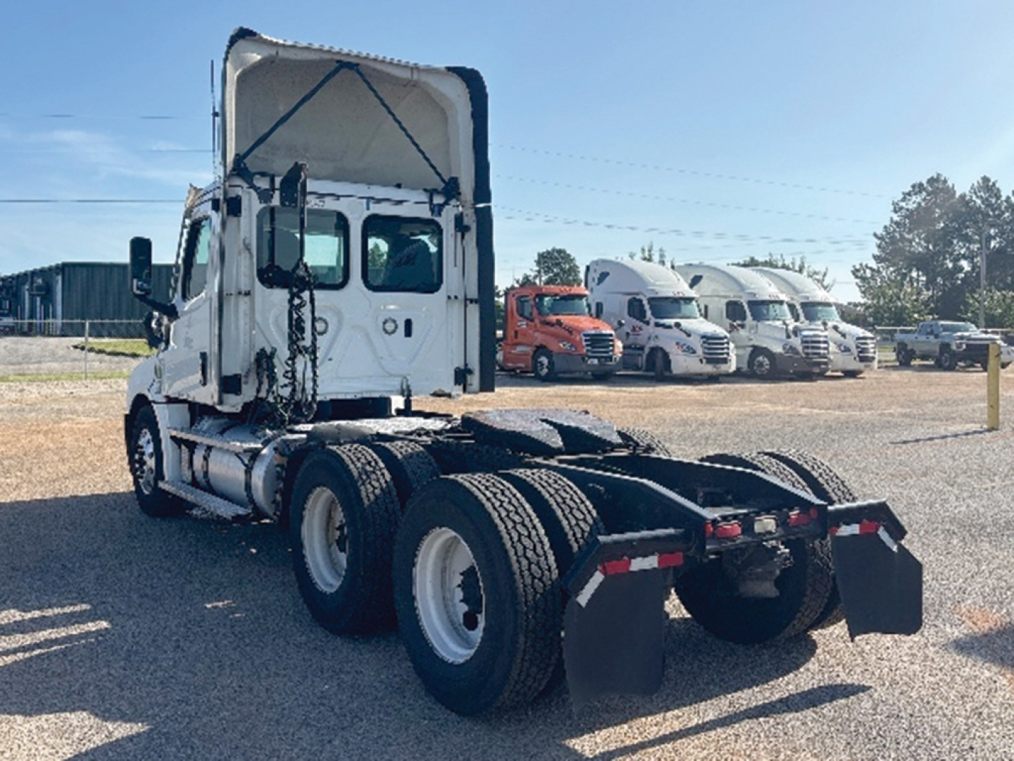 Freightliner Cascadia126 tractor rear view showing chassis and dual rear axles with fifth wheel and tandem setup.