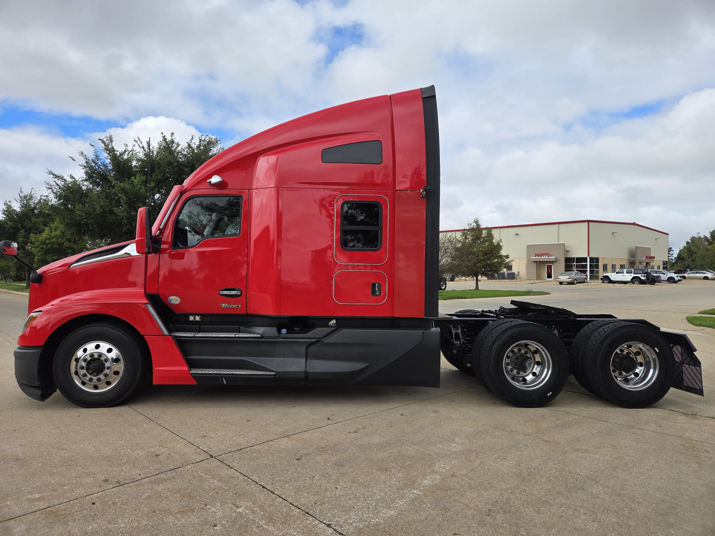 Kenworth T680 side profile showing sleeper cab and rear axles with dual rear wheels.