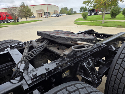 Kenworth T680 chassis view showing fifth wheel area and cab connection; visible springs, hoses, and frame rails.