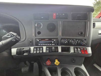 Kenworth T680 dashboard interior view showing center console with switches and climate controls.