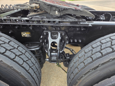 Truck rear view showing fifth wheel hitch and dual rear axles on a Kenworth T680 chassis