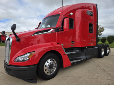 Kenworth T680 red semi-truck side view showing cab and front wheel, sleeper configuration, chrome fuel tanks, and dual rear axles.