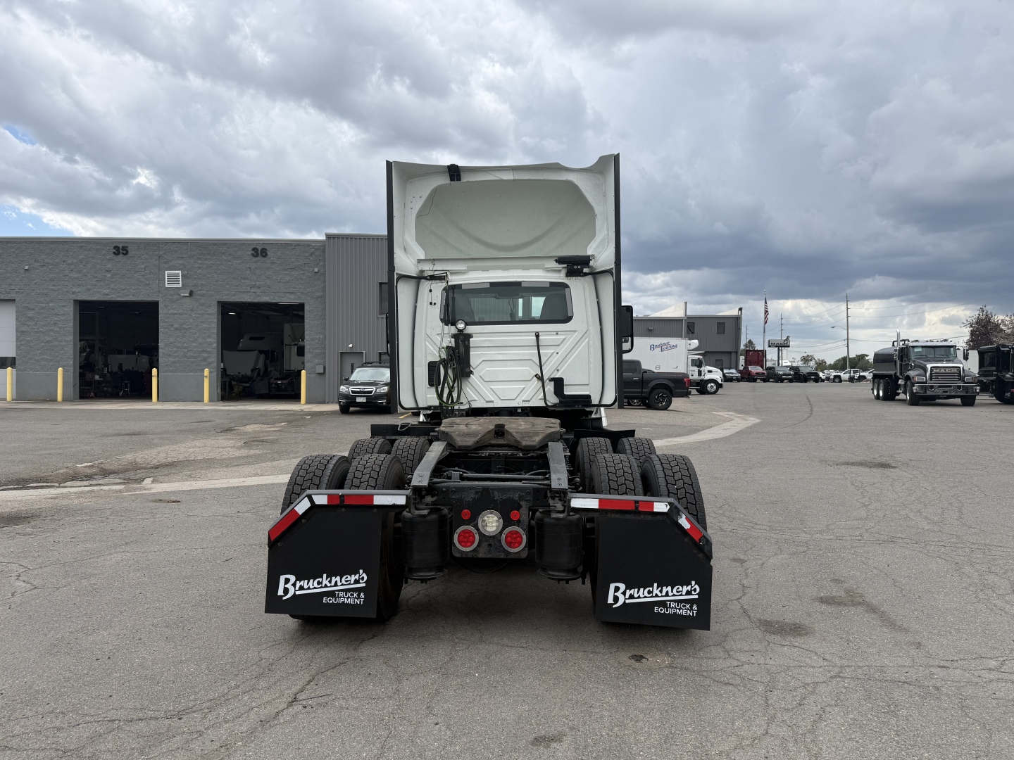 Rear view of a 2021 International LT625 truck tractor showing dual rear axles, mud flaps with Bruckner's logo, and rear lights. No visible cargo.