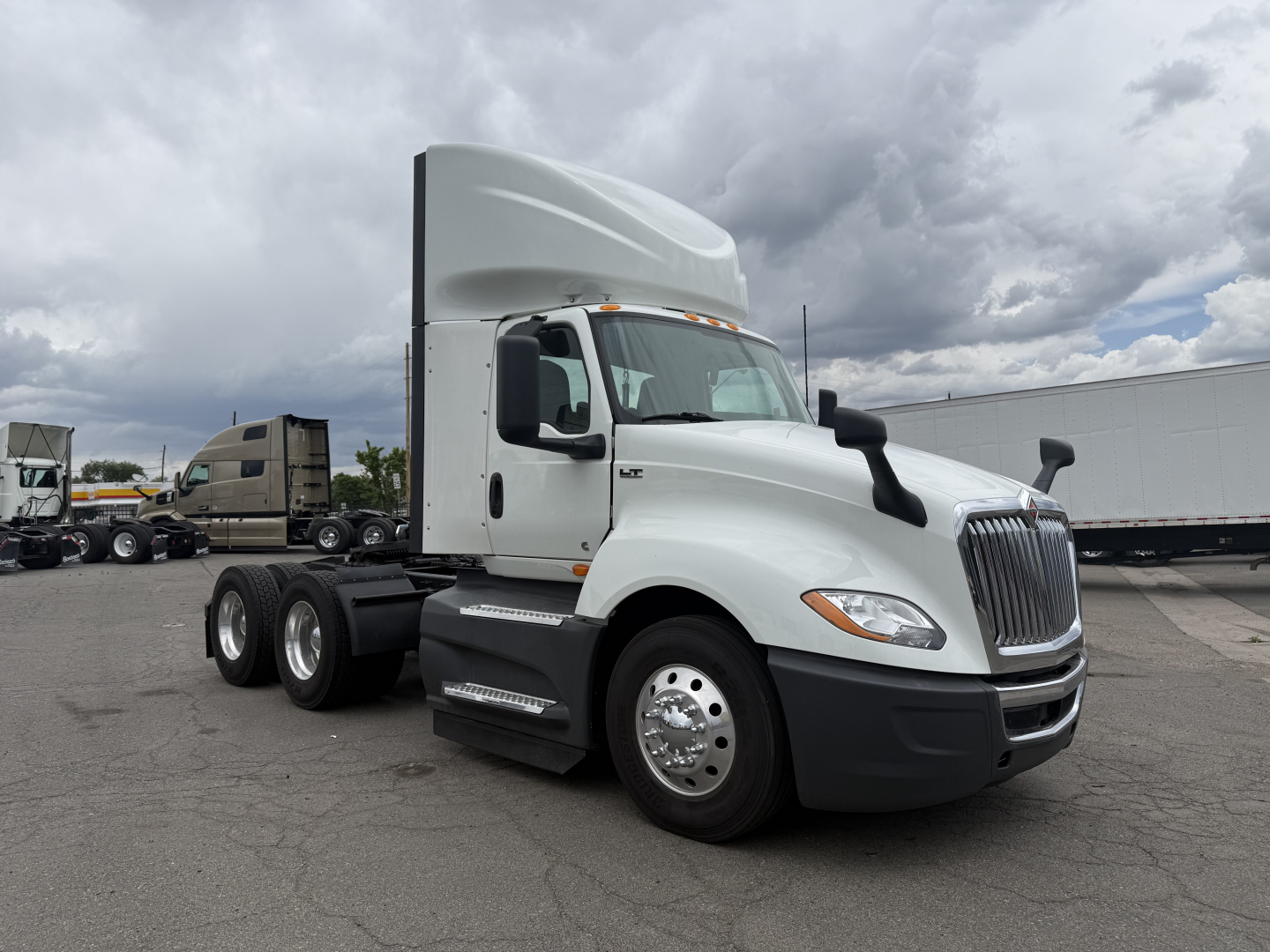 International LT625 truck in side view showing sleeper cab and 6x4 tractor with dual rear axles and chrome wheels.