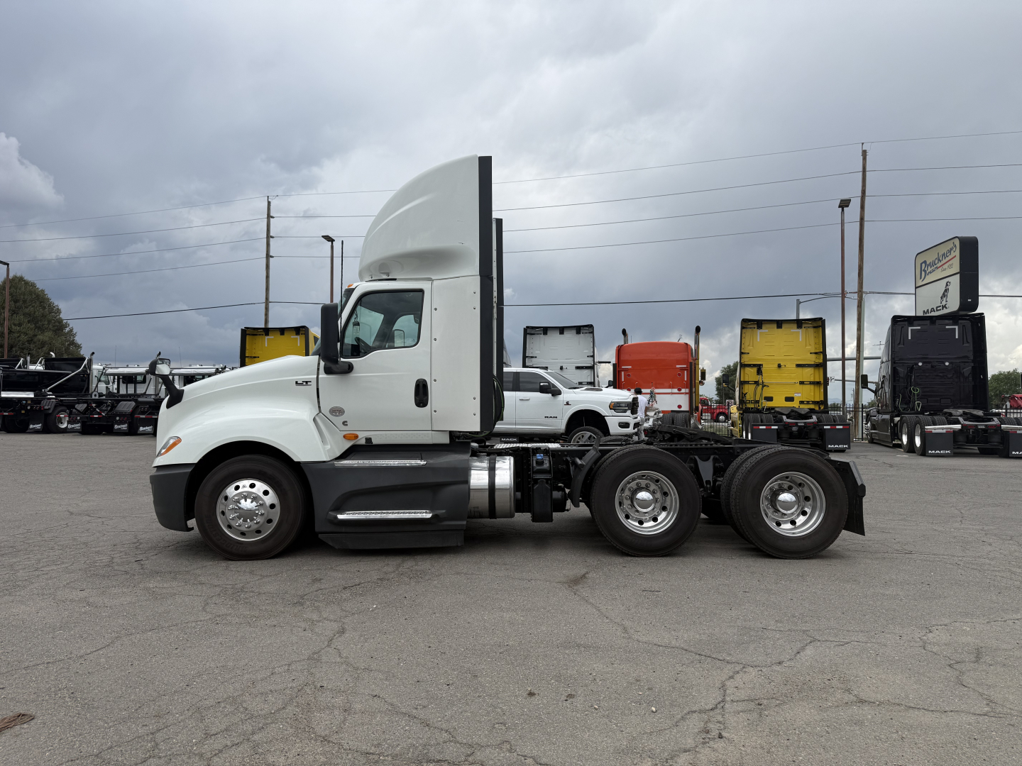 Truck cab and chassis showing International LT625 badge area and twin rear axles in a lot.