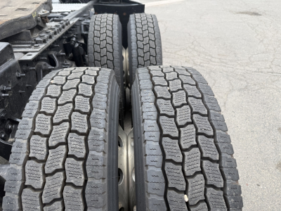 Truck rear dual tires on a 2021 International LT625 chassis showing tread pattern and wheel hubs.