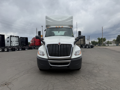 Front view of a white 2021 International LT625Conventional Daycab truck showing grille, headlights, bumper, and large hood. No visible text.