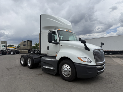 International LT625 truck in side view showing sleeper cab and 6x4 tractor with dual rear axles and chrome wheels.