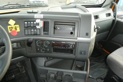 Dashboard view of a Volvo truck interior showing assorted controls, vents, and a blank radio slot.