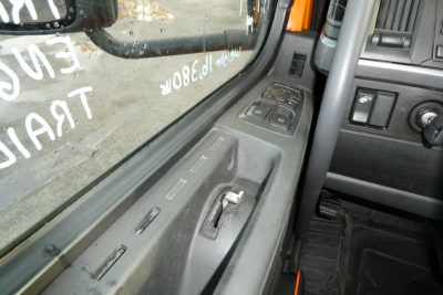 Truck cab interior window and door panel with window controls visible.