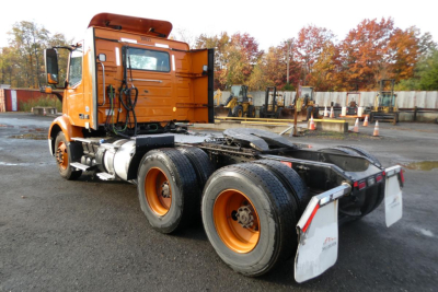 2019 Volvo VNR rear/side view showing dual rear axles and orange accents with cab and chassis, no trailer attached.