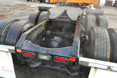 Rear undercarriage of a Volvo truck showing multiple wheels, chassis/frame, and fifth wheel area.