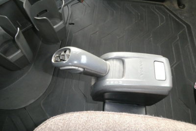Volvo internal gear shifter in a 2019 VNR64T300 Day Cab truck interior showing automatic transmission shifter and floor mat.