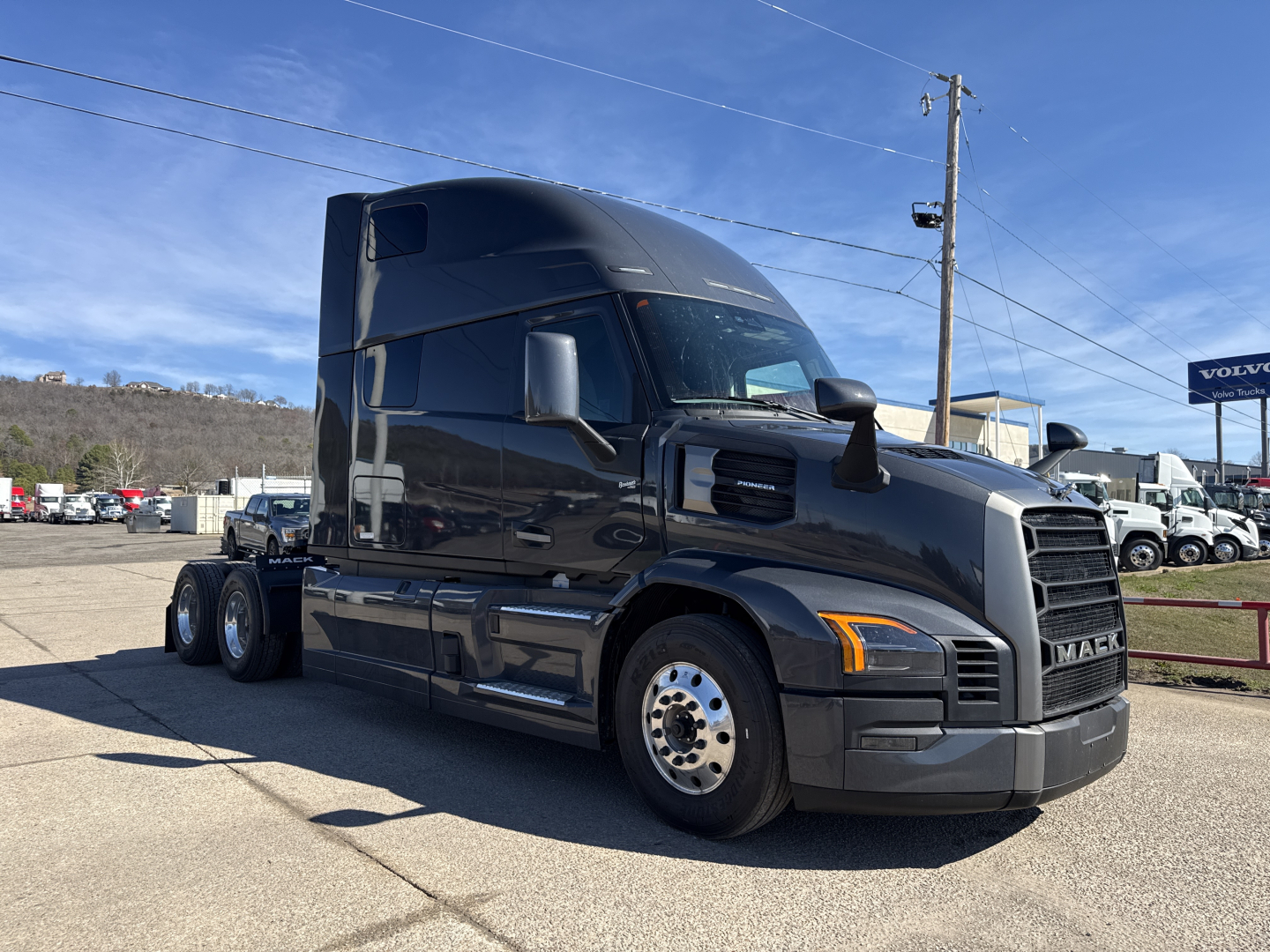 Mack PR64T76H conventional sleeper tractor in service bay showing cab and front grille.