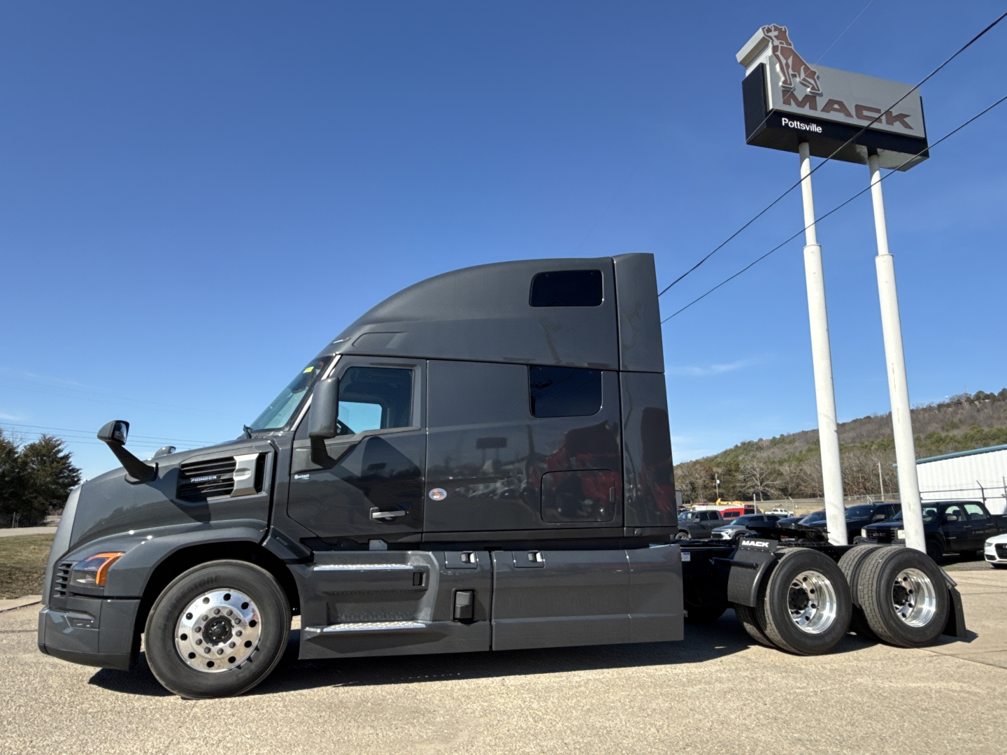 2026 Mack PR64T76H truck tractor side profile in dealership lot showing sleeper cab and dual rear axles.