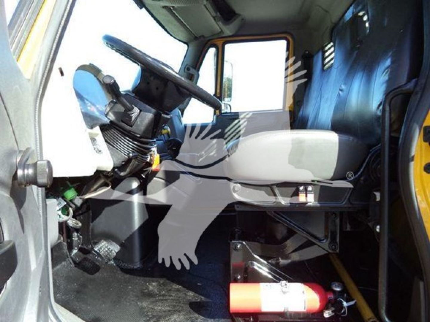 Interior of 2019 International Durastar 4300 cab showing driver seat and steering wheel with dashboard and blue seat cover.