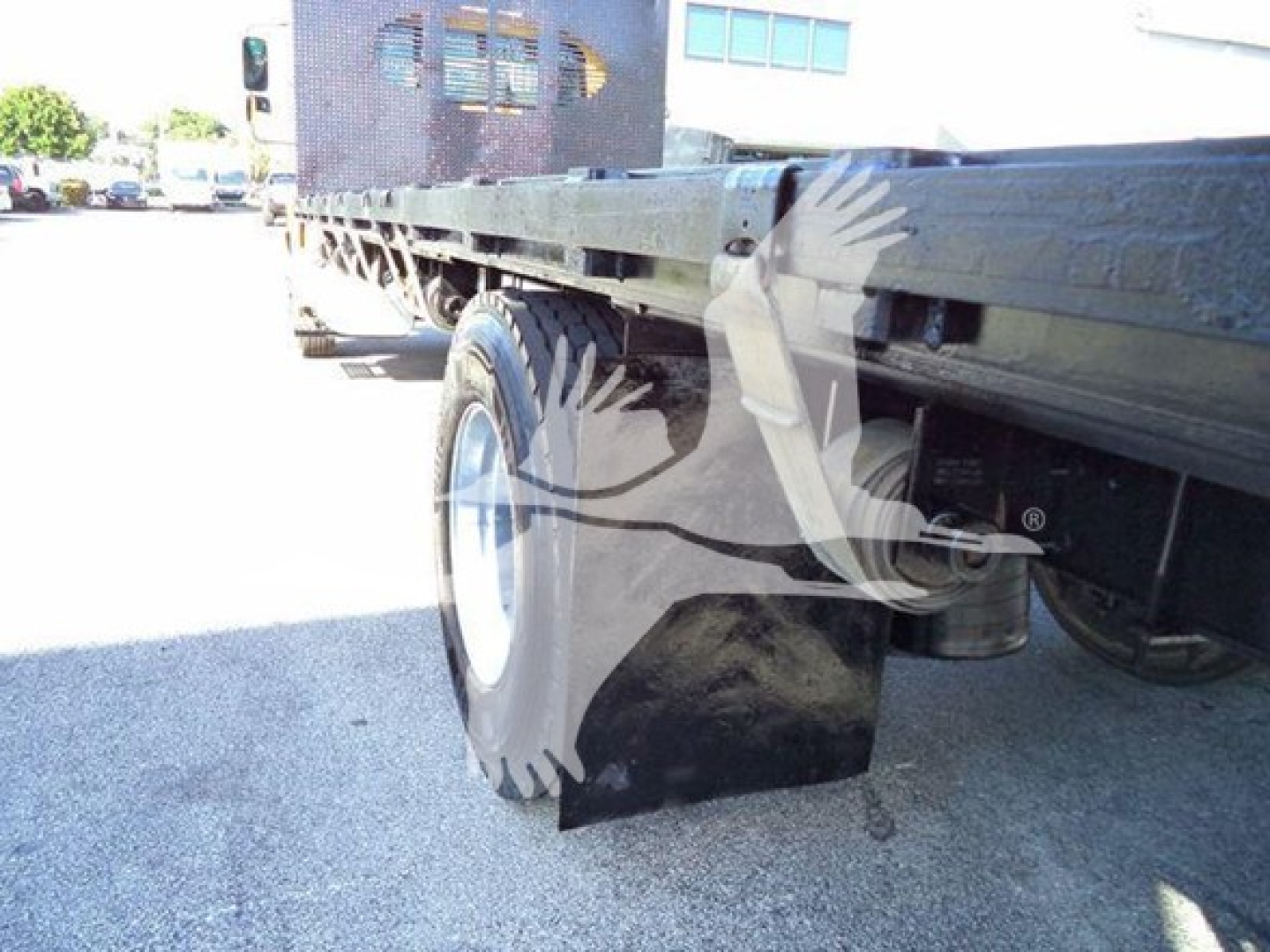 Flatbed truck rear wheel and undercarriage of a 2019 International Durastar 4300 showing flatbed frame and dual rear tires.