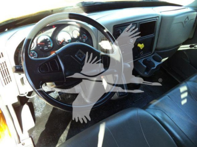 Interior of a 2019 International Durastar 4300 cab showing steering wheel, dashboard gauges, and center console; visible overlay graphic partially obscures some area.