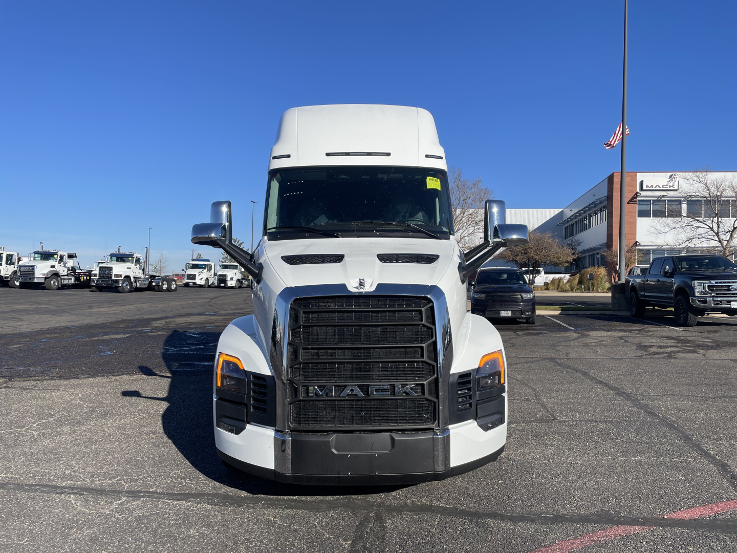Front view of a white 2026 Mack PR64T76H truck cab with large grille and headlights.