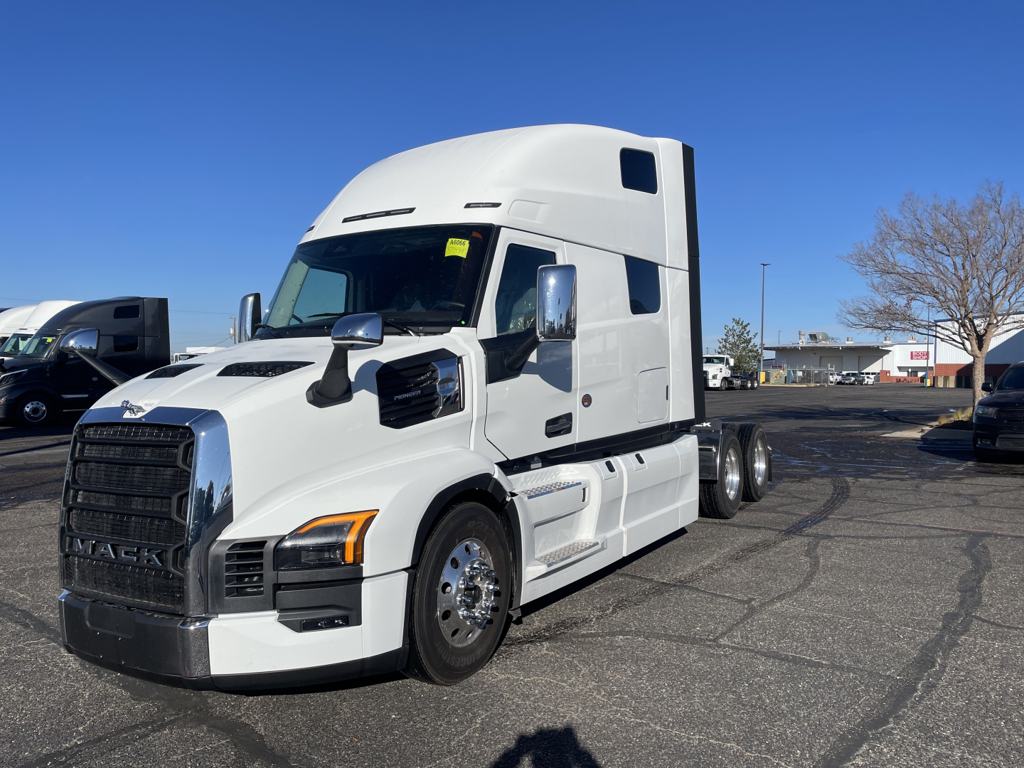 Mack PR64T76H conventional sleeper tractor in white, side view showing tractor cabin and wheels, no visible text on vehicle parts.