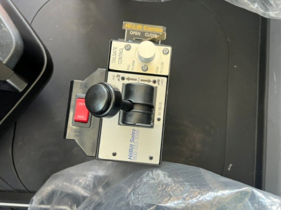 Console control panel with toggle switch, joystick, and label text. Visible text includes 'Hi-Lift Combo', 'OPEN', 'CLOSE', 'TILTING', 'TRAILER CABLE', 'GUIDE', 'SOLID', and 'Hillbill Sails' (likely 'Hillbill Sales' on the side). The panel 