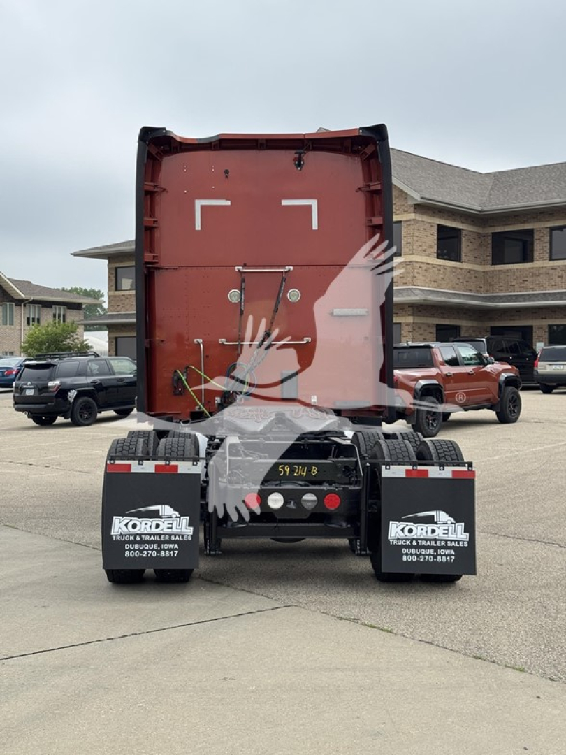 Kenworth T680 rear view showing sleeper cab and bumper with stock number plate on trailer hitch area.