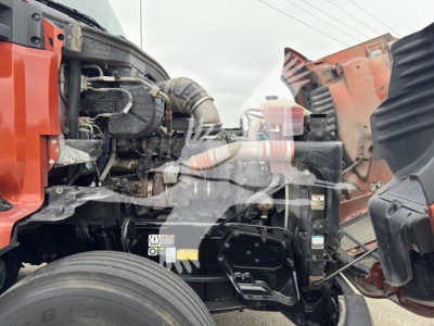 Kenworth T680 engine bay in-view showing air intake hose and partial chassis components.