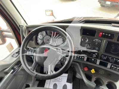 Kenworth T680 interior cab view showing steering wheel and dashboard with gauges and control panels
