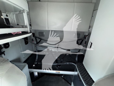 Kenworth T680 sleeper cab interior cargo area view with partition and storage shelves visible.