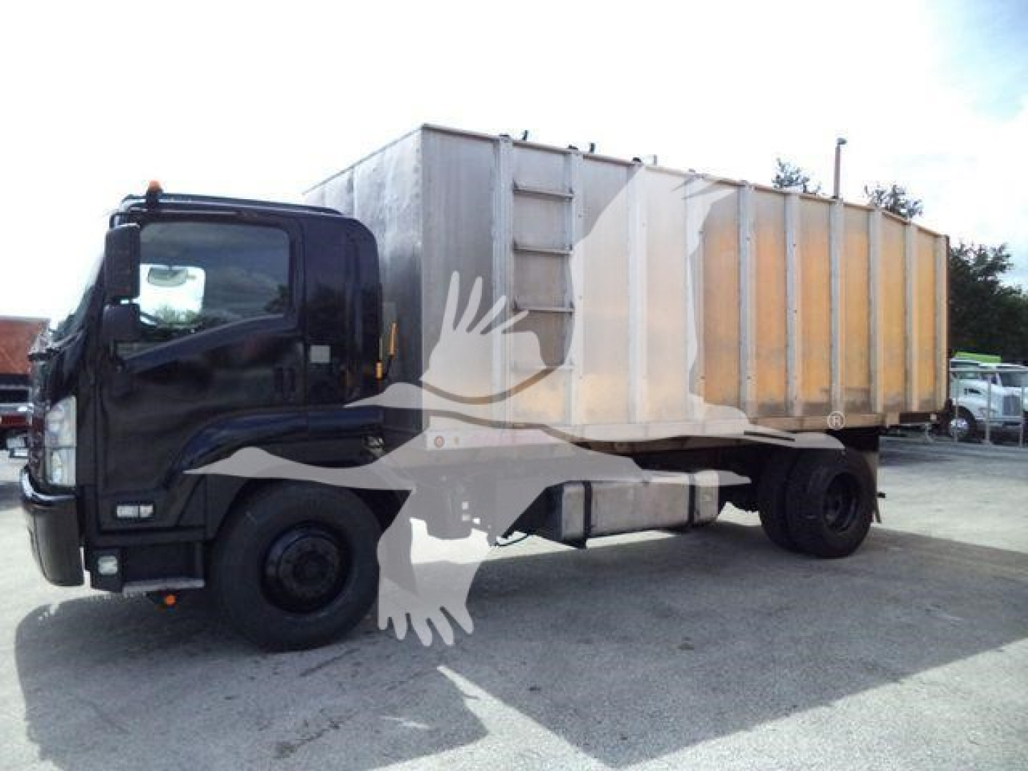 Isuzu FTR truck with dump body in service side view showing cab and long rear dump bed.