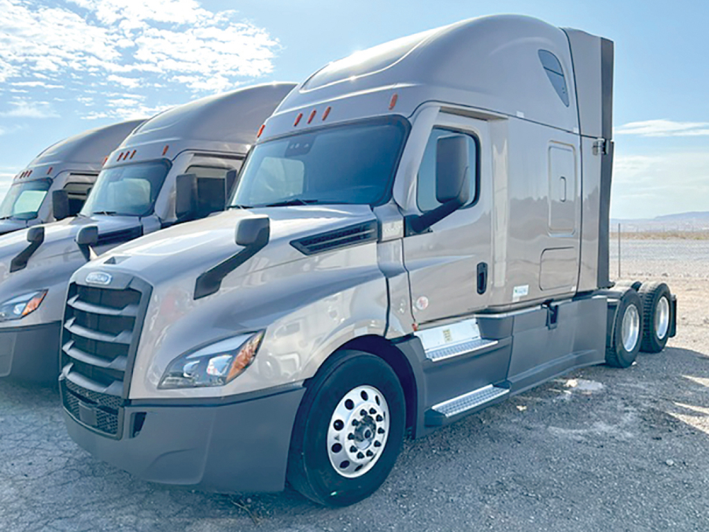 Freightliner Cascadia126 sleeper tractor; front-left view showing cab, aerodynamic mirrors, gray paint, and side steps.
