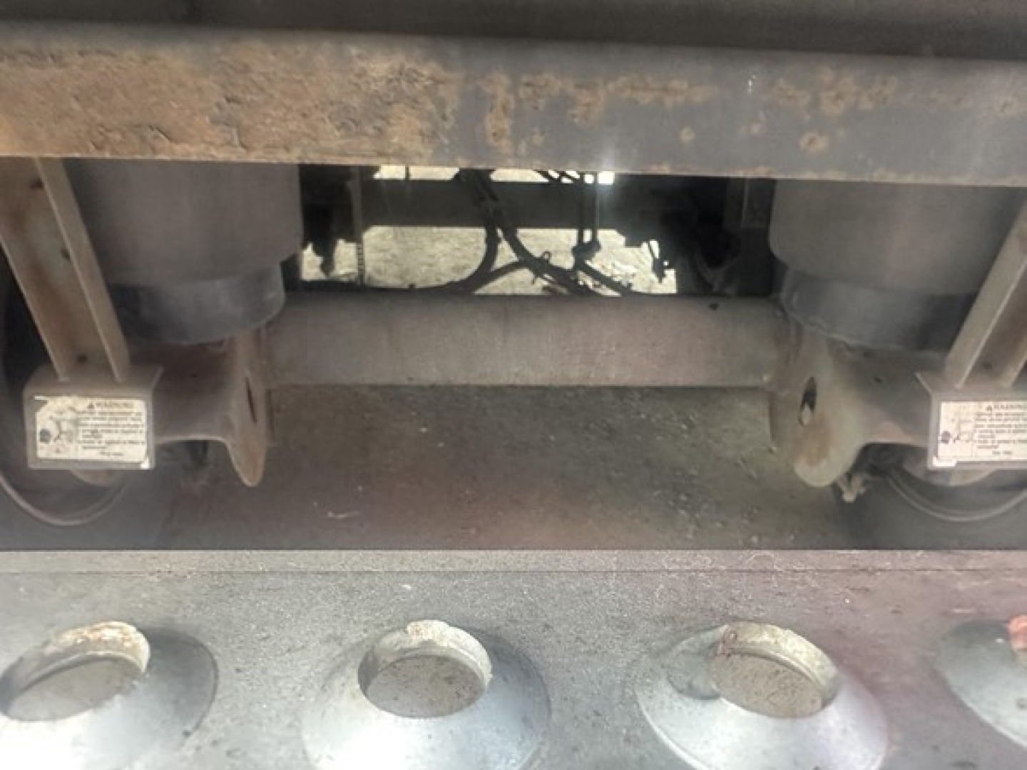 Trailer underside view showing landing gear and suspension components of a 2015 Utility 3000R reefer trailer.