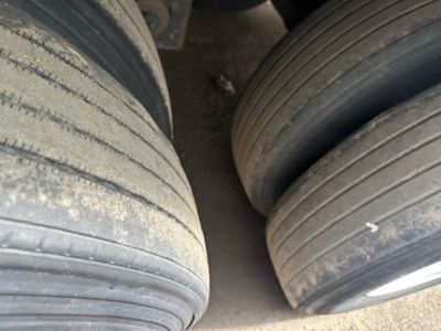 Trailer tires and side of 2015 Utility 3000R trailer wheel area showing tread and sidewall details.