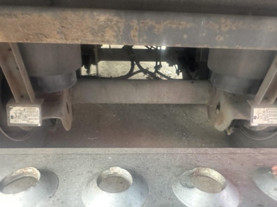 Trailer underside view showing landing gear and suspension components of a 2015 Utility 3000R reefer trailer.
