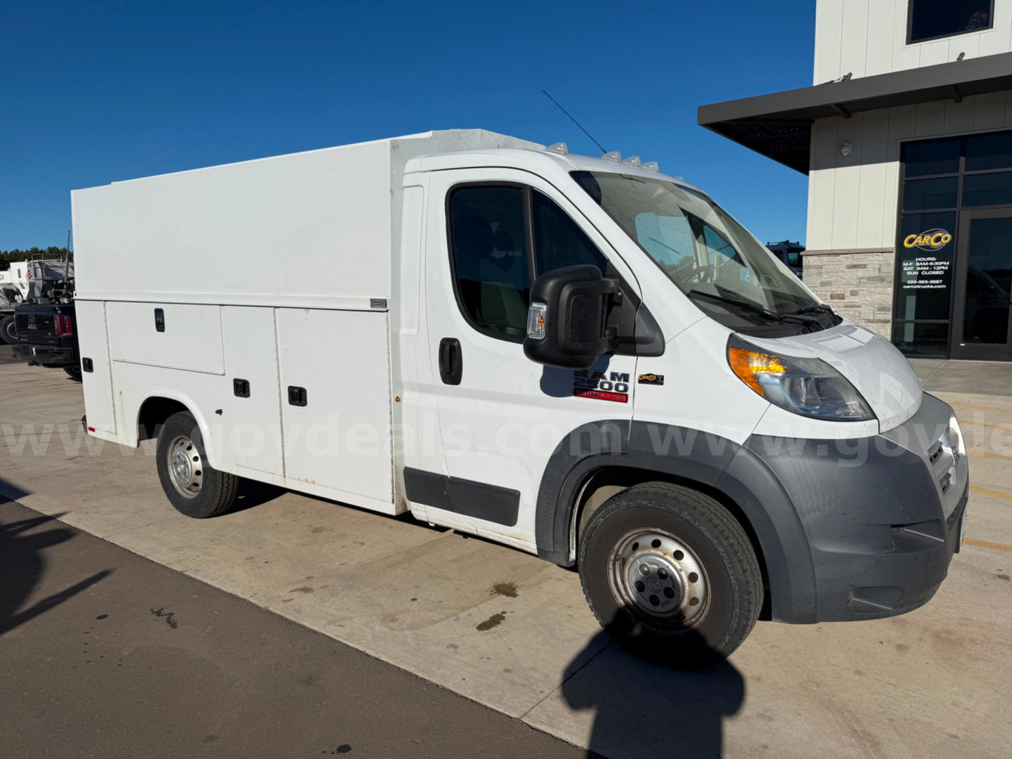 Ram ProMaster service van side view showing cargo box with multiple access panels and plain white exterior.
