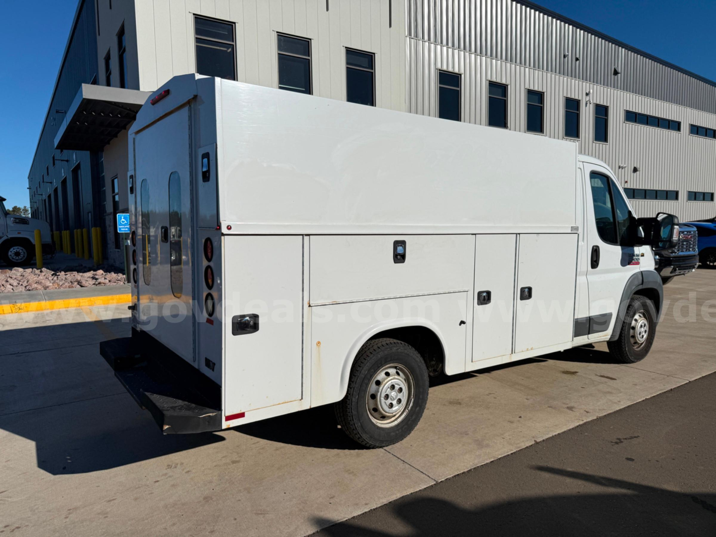 Ram ProMaster service utility van 2015 rear and side view showing cargo compartments and utility boxes.
