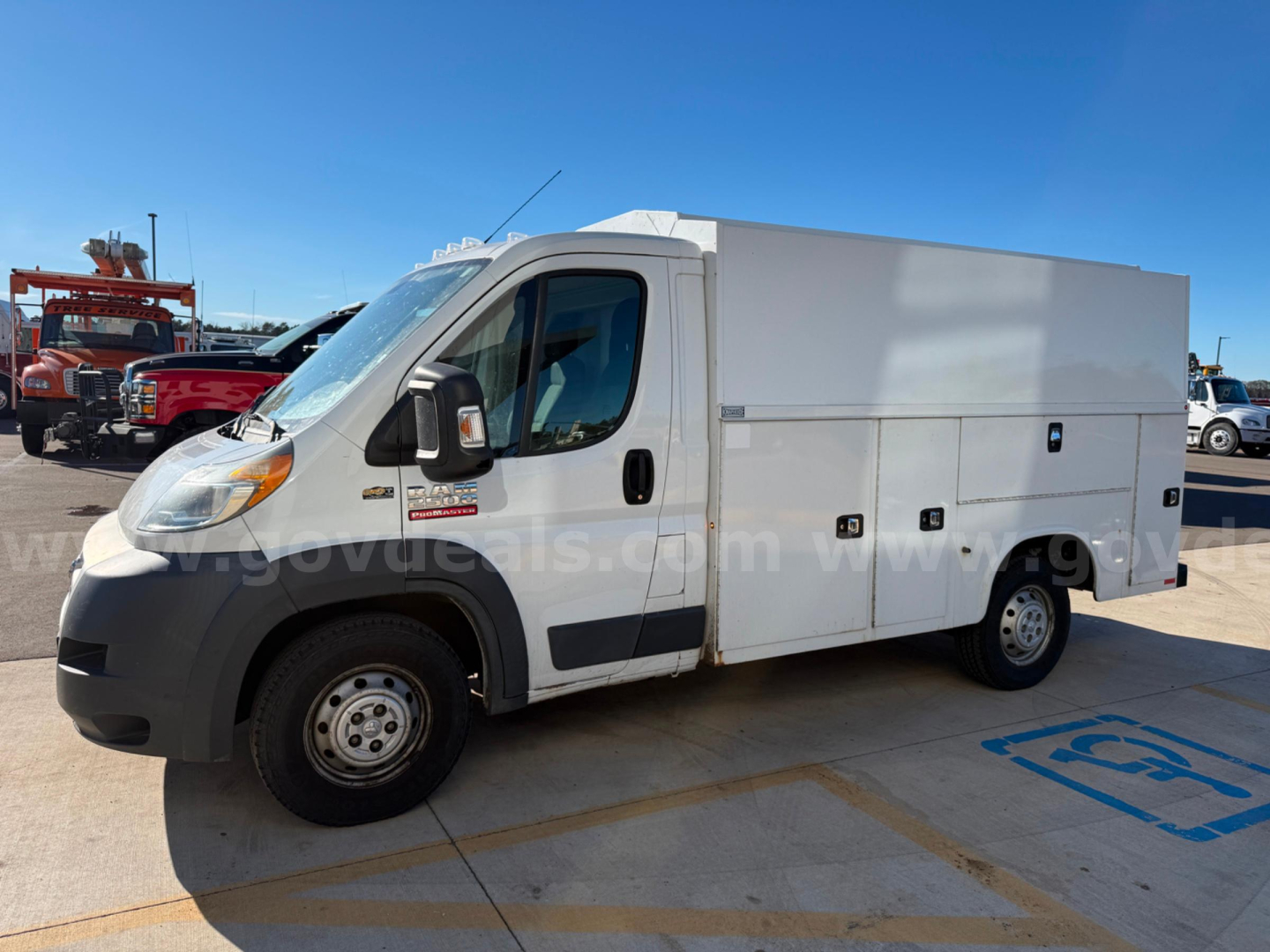 Ram ProMaster service/utility van with utility box body in a dealership lot, white cargo area, front driver's side view.