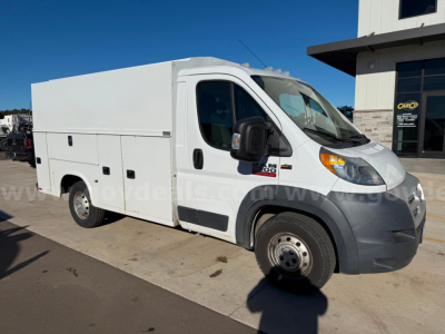 Ram ProMaster service van side view showing cargo box with multiple access panels and plain white exterior.