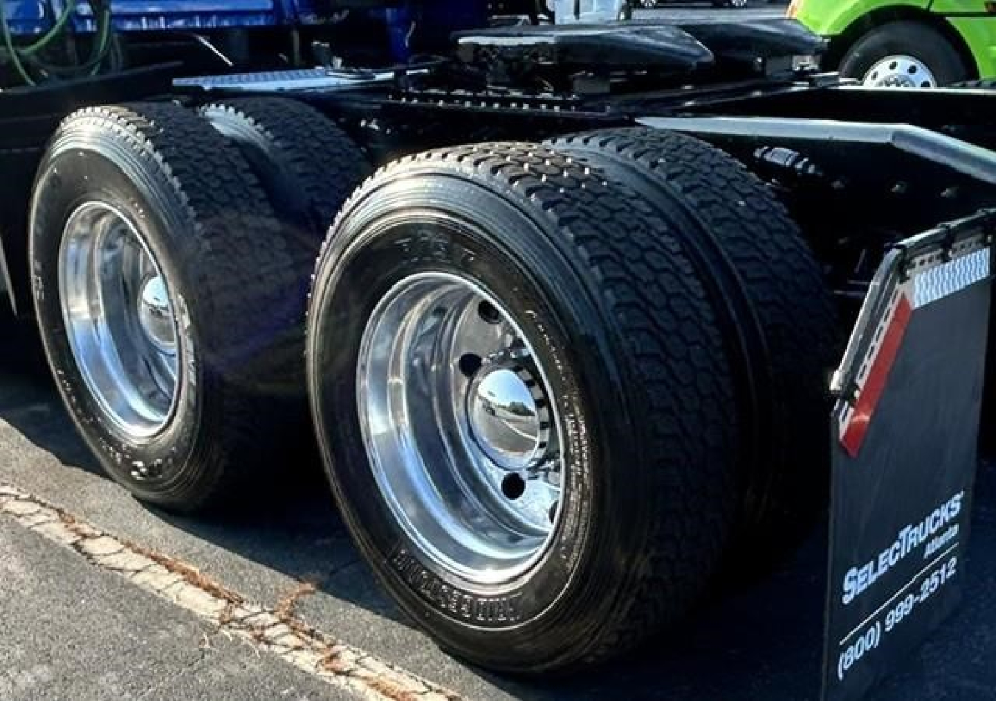 Freightliner Cascadia 126 truck chassis showing dual rear axles with polished wheels and tires, part of sleeper tractor configuration.