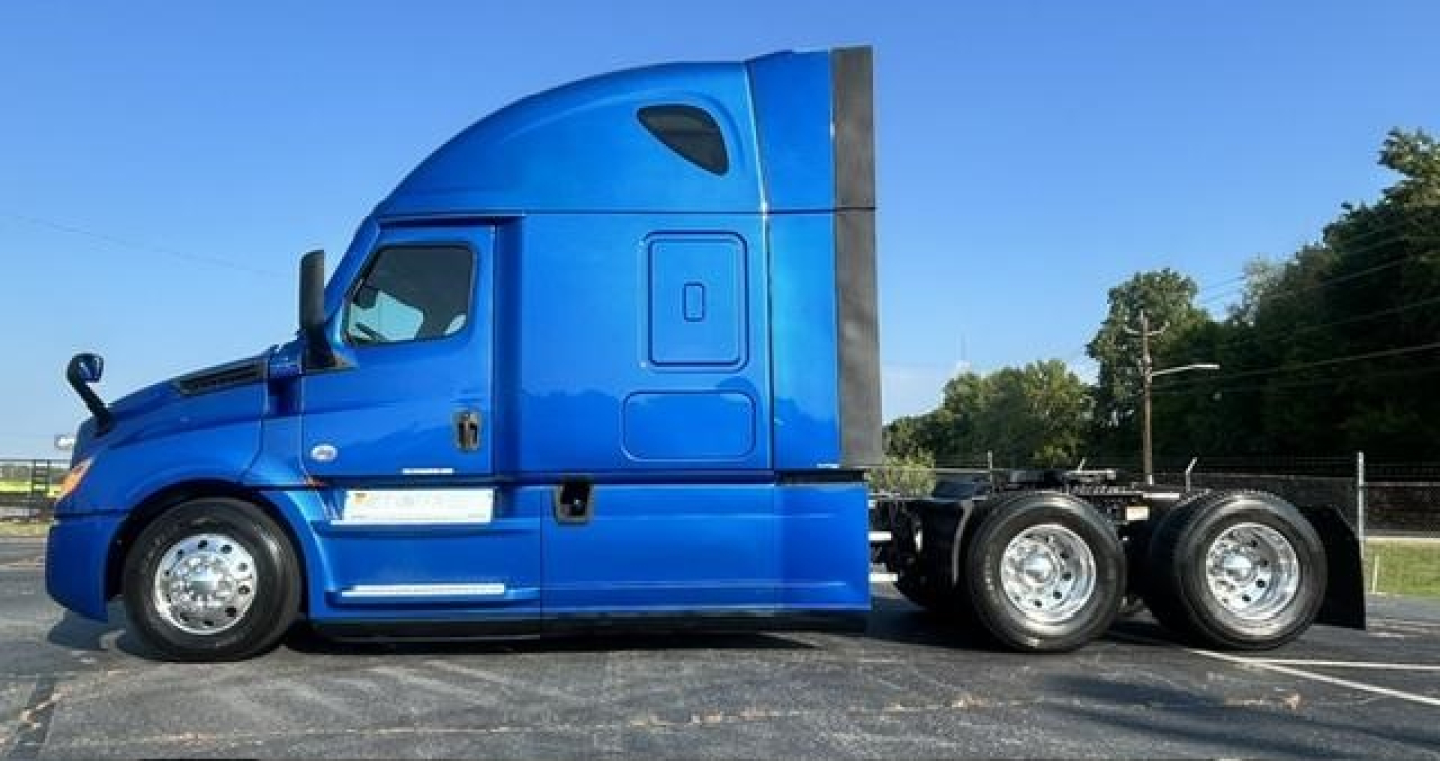 Freightliner Cascadia 126 sleeper tractor in blue, side profile view with fuel tanks and wheels visible