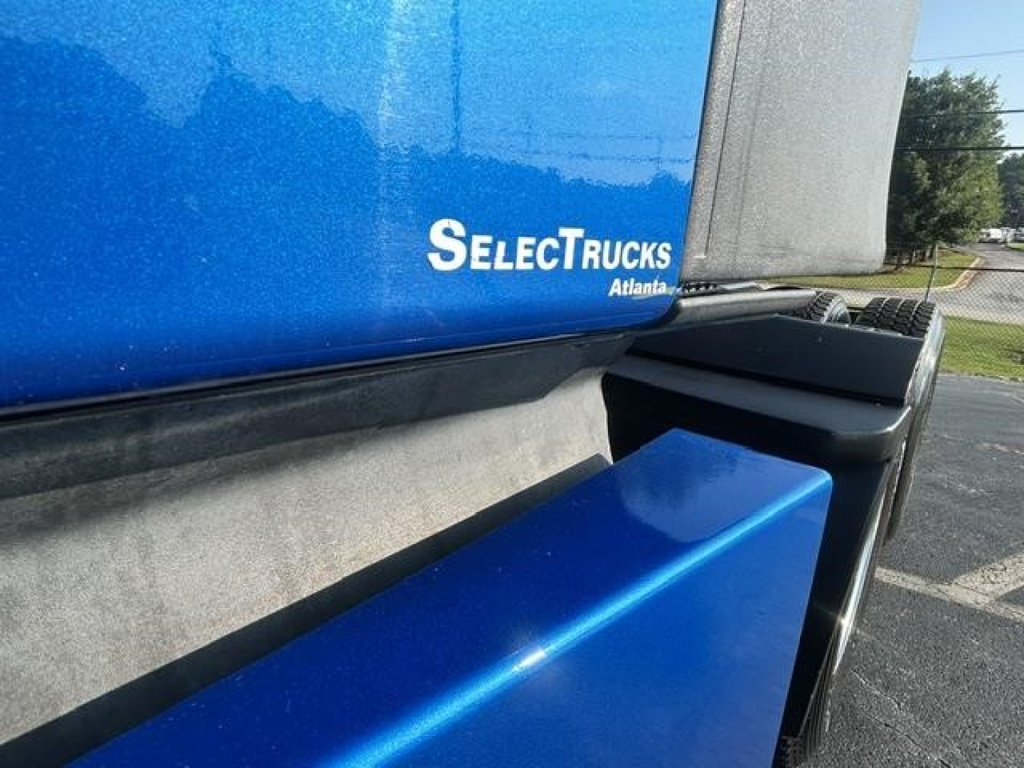 Truck bed area of a 2021 Freightliner Cascadia 126 showing the blue sleeper shell with SelectTrucks Atlanta logo and a blue storage box.