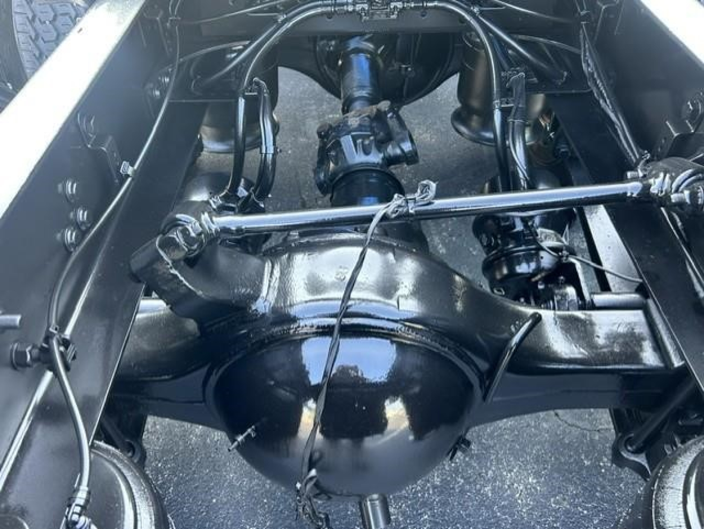 Freightliner Cascadia 126 rear axle and suspension view showing differential housing, leaf springs, and driveline components.