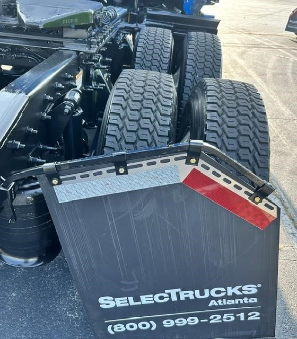 Truck rear view showing tandem axles and mudflap with SelectTrucks Atlanta branding.