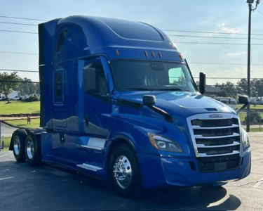 Freightliner Cascadia 126 sleeper cab truck in blue, front three-quarter view showing chrome grille, headlights, and aerodynamic mirrors