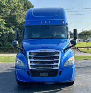 Front view of a blue Freightliner Cascadia 126 tractor-trailer cab with grille, headlights, and aerodynamic mirrors visible.