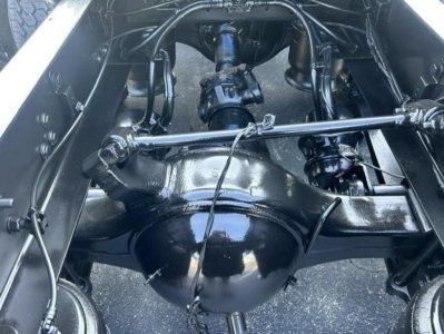 Freightliner Cascadia 126 rear axle and suspension view showing differential housing, leaf springs, and driveline components.