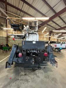 Rear view of a Hino truck boom setup showing rear hitch, taillights, and black bumper with hydraulic components.