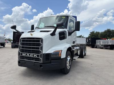 White 2027 Mack AN64 dump truck front-left view showing grille with MACK lettering and large side mirrors.