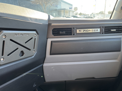 Dashboard view of a 2027 Mack PR64T truck showing Pioneer badge on the dash and Mack-branded instrument panel area.